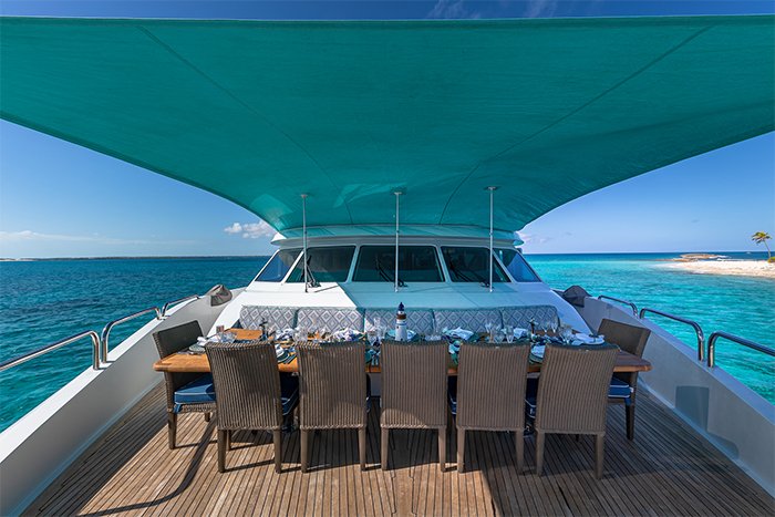 Motor yacht Sweet Escape deck dining with bimini